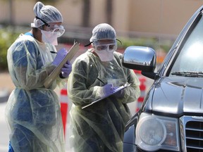 Hospital staff perform drive-thru tests for coronavirus disease (COVID-19) in Indian Wells, California.