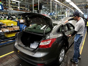 Employee works in Ford Motor Co.’s assembly plant in Wayne, Michigan. Ford says it would close its North American plants after Thursday evening's shifts through March 30 to thoroughly clean the factories in the United States, Canada and Mexico.