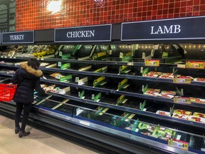 People shop at a grocery store in Toronto, on March 13, 2020.