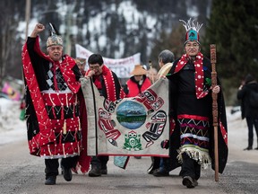 Chief Madeek (Jeff Brown), front left, hereditary leader of the Gidimt'en clan, and Wet'suwet'en Hereditary Chief Namoks (John Ridsdale), front right, carry a flag while leading a solidarity march after Indigenous nations and supporters gathered for a meeting to show support for the Wet'suwet'en Nation, in Smithers, B.C., on Wednesday January 16, 2019.