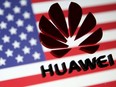 A 3D printed Huawei logo is placed on glass above displayed US flag in this illustration taken January 29, 2019.