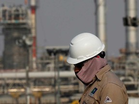 An employee looks on at Saudi Aramco oil facility in Abqaiq, Saudi Arabia.