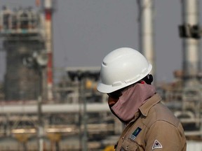 An employee looks on at Saudi Aramco oil facility in Abqaiq, Saudi Arabia. The United Arab Emirates followed Saudi Arabia on Wednesday in promising to raise oil output to a record high in April.