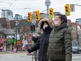 Women in downtown Toronto's Chinatown wear protective masks on Jan. 27, 2020.