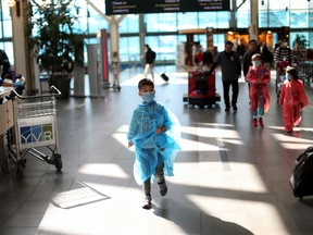 A child walks towards the international security screening point of the Vancouver International Airport after Prime Minister Justin Trudeau announced additional measures to combat the spread of the coronavirus disease (COVID-19), in Richmond, British Columbia, March 16, 2020.