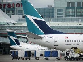 A WestJet plane sit at Toronto’s Pearson International Airport. The airline said on Tuesday that 6,900 employees would leave the company, with 90 per cent departing voluntarily.