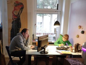 Holger Frohnmeyer, working from home, studies with his son Rasmus during the spread of coronavirus disease in Berlin.