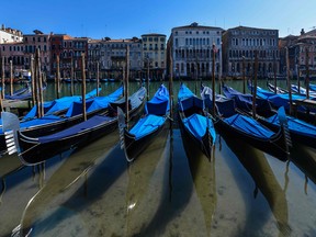 A view shows clear waters by gondolas in Venice's Grand Canal on March 18, 2020 as a result of the stoppage of motorboat traffic, following the country's lockdown within the new coronavirus crisis.