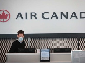 An Air Canada worker waits for travellers at a nearly-empty O'Hare International Airport on April 2, 2020 in Chicago, Illinois.