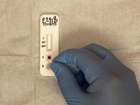 A medical practitioner uses a blood sample from a patient for a COVID-19 antibody test, in Richmond, Texas, U.S.