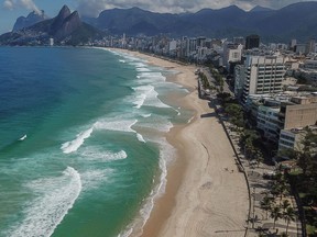 Ipanema and Leblon beaches are seen nearly empty in this aerial photograph taken above Rio de Janeiro, Brazil, on Monday, April 20, 2020. President Jair Bolsonaro has urged Brazilians to resume work even as deaths from COVID-19, which he has called just a"sniffle", near 2,500.
