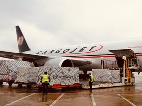 Handlers offload cargo off a Cargojet plane. On Saturday, the first of multiple flights from Shanghai landed in Ontario with a supply of masks and equipment for Canadian healthcare workers.