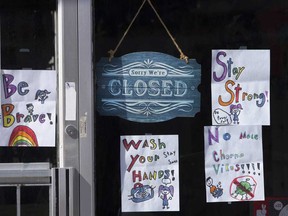 A storefront window on a closed business in Toronto.  The Ontario Chamber of Commerce says the wait for the federal government’s wage subsidy is far too long to avoid layoffs on a scale that economists suggest will leave many businesses unable to operate once the economy restarts.