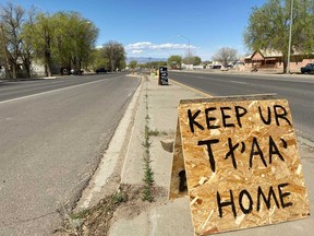 A road sign made by a local student asks residents to keep their "TtAAs" or "butts", in The Navajo language, home during the severe coronavirus disease outbreak in the Navajo reservation, in Shiprock, New Mexico.