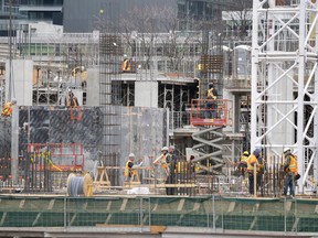 Workers are shown at a construction site in Toronto on Wednesday, March 18, 2020.