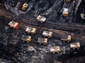 Heavy haulers are seen at the Suncor Energy Inc. Fort Hills mine in this aerial photograph taken above the Athabasca oil sands near Fort McMurray, Alberta.