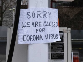 A sign at a gas station alerts customers that a business in Queens, which has one of the highest infection rates of coronavirus in the nation, is closed in New York City.
