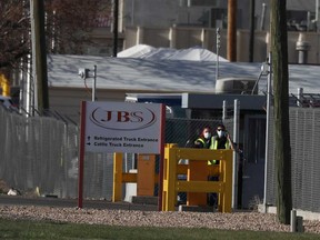 Security wear face mask at JBS USA meat packing plant, where two members of the staff have died of coronavirus disease in Greeley, Colorado.