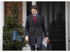 Prime Minister Justin Trudeau passes a scarf with the tartan of Nova Scotia adorning a tree as he arrives for his daily press conference on the COVID-19 pandemic, outside his residence at Rideau Cottage in Ottawa, on Friday, April 24, 2020.
