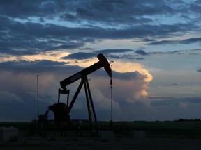 Storm clouds form and brew over and behind pumpjacks in Acme, Alta., northeast of Calgary.