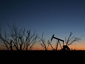 The silhouette of a pumpjack is seen at dusk in the Permian Basin near Midland, Texas.