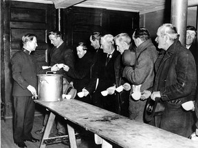 A Salvation Army relief worker tends to a line at a soup kitchen in an undated photo from during the Great Depression.