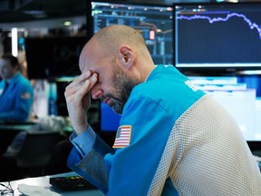 Traders work on the floor of the New York Stock Exchange on March 18, 2020. The Dow fell more than 1,200 points that as COVID-19 fears roiled world markets.