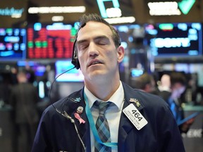 Traders work on the floor at the closing bell of the Dow Industrial Average at the New York Stock Exchange on March 11, 2020 in New York.