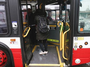 person getting on a TTC bus in Toronto