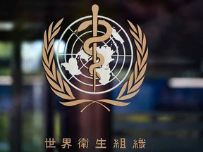 The sign of the World Health Organization (WHO) written in Chinese at the entrance of their headquarters in Geneva.