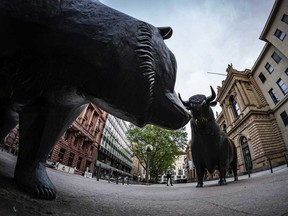 A bear statue faces a bull statue outside the Frankfurt Stock Exchange.