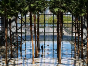 A security guard walks across the atrium of Brookfield Place, a shopping mall in Manhattans Financial District, sits empty on May 5, 2020 in New York City.