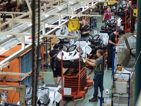 Workers at the manufacturing line for the BRP Tundra snowmobile at the BRP assembly plant in Valcourt, Quebec on Tuesday, July 4, 2017.