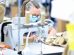 A machinist sews a protective gown for a worker in the U.K. National Health Service (NHS) at the Burberry Group Plc factory in Castleford, U.K.