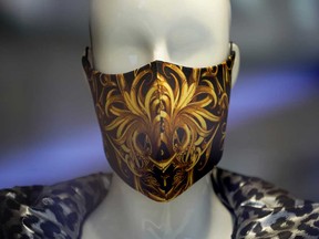 A mannequin in a shop window wears a fashionable protective face mask during the coronavirus crisis.