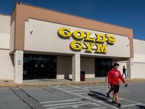 People walk near to the entrance of Gold's Gym, one of the businesses that reopened after a shutdown to prevent the spread of the coronavirus disease (COVID-19) in Augusta, Georgia, U.S., April 26, 2020.