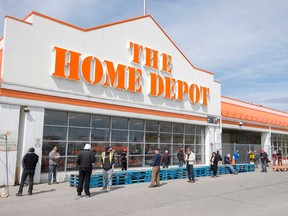 A line up of customers outside an Ottawa Home Depot wait to enter the store.