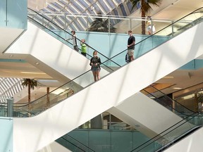 Shoppers wear protective masks at the Galleria Dallas mall in Dallas, Texas, U.S., on Monday, May 4, 2020, after Texas Governor Greg Abbott announced that all restaurants, malls, and stores could reopen on May 1.