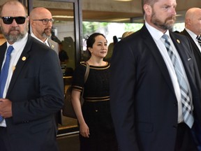 Huawei Chief Financial Officer, Meng Wanzhou (C), leaves British Columbia Supreme Court, after hearing the decision of Associate Chief Justice Heather Holmes on her double-criminality judgment in Vancouver, on May 27, 2020.