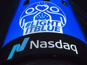 A billboard is illuminated in blue in honour of first responders and front line workers battling coronavirus at the Nasdaq MarketSite in the Times Square area of New York.