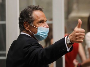 New York Governor Andrew Cuomo arrives at the New York Stock Exchange on the first day that traders are allowed back onto the historic floor of the exchange on Tuesday.