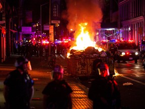 A pile of burning garbage set by demonstrators is seen during looting after marching against the death in Minneapolis police custody of George Floyd, in the Manhattan borough of New York City, U.S., June 1, 2020.