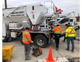 Workers get set to pour cement from a truck at the GO train station in Oakville, Ont., Tuesday, Jan.28, 2020. Statistics Canada is set today to report how many workers lost their jobs in April or had their hours slashed as a result of the COVID-19 pandemic.THE CANADIAN PRESS/Richard Buchan