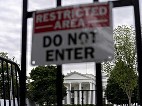 The White House stands past fencing in Washington, D.C., U.S., on May 20. President Donald Trump today said he may reschedule a meeting of the Group of Seven (G-7) nations to take place at Camp David, after having canceled the in-person gathering due to the coronavirus pandemic.