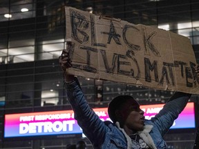 Protesters march through the streets of Detroit, Michigan for a second night May 30,2020, protesting the killing of George Floyd who was killed by a white officer who held his knee on his neck for several minutes during an arrest in Minneapolis on Monday.