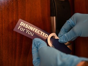 A cleaner puts a sticker on a room door at a luxury hotel in Turkey.