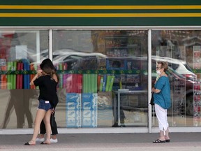 Customers observe social distancing guidelines outside a Dollarama in Winnipeg in May.