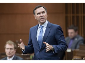 Finance Minister Bill Morneau rises during Question Period in the House of Commons Tuesday May 26, 2020 in Ottawa. The Canadian Association of Petroleum Producers says if bridge loans for smaller oil and gas companies aren't ready to flow soon some companies will have to turn to less-safe options to survive the COVID-19 slowdown.THE CANADIAN PRESS/Adrian Wyld