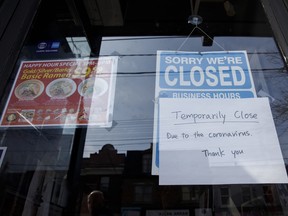 A closed sign is displayed on the door of a restaurant in Toronto, Ontario, Canada, on Wednesday, March 25, 2020. The unemployment rate in Ontario, which accounts for almost 40 per cent of Canada’s output, was running at close to a record low before the province ordered all but essential businesses to shut down in a bid to contain the virus.