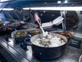 McEwan Supermarket barista Natasha Cole works at the store's hot food bar on June 25, 2020.